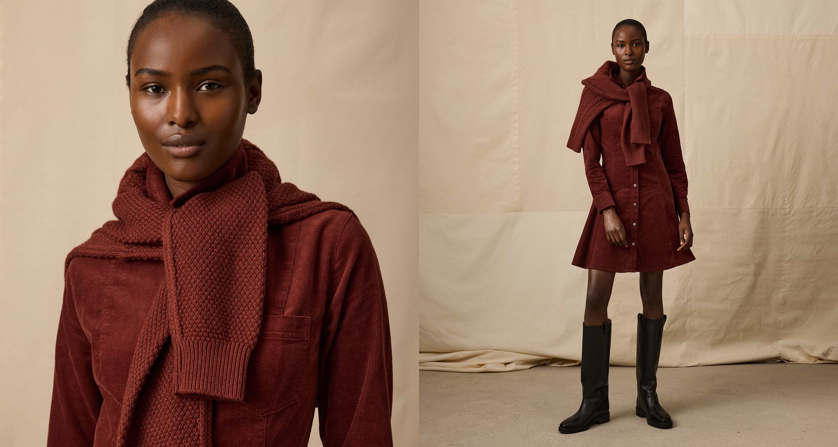 Person wearing a rust corduroy shirt dress with a matching knit scarf and black knee-high boots against a beige backdrop.