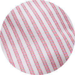 Close-up of white fabric with diagonal red stripes.