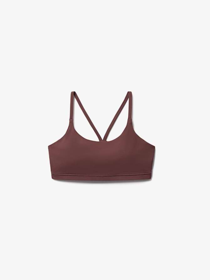 Brown sports bra with thin crisscross back straps, shown on a white background.