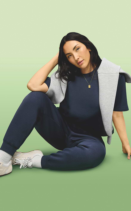 A female model wears High-Waisted SleekTech Joggers.