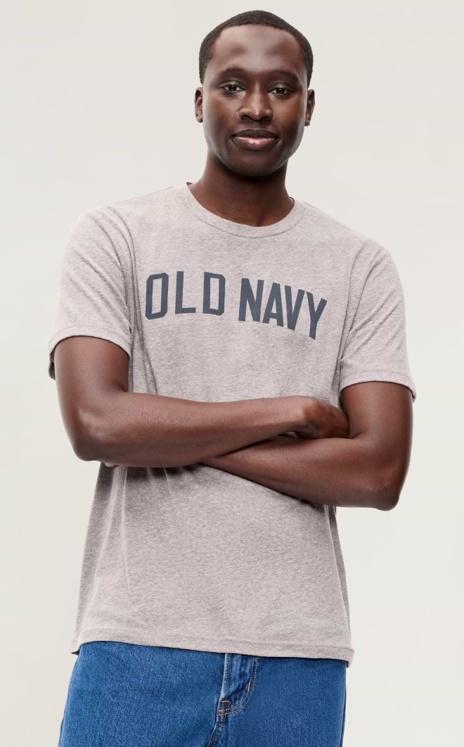 Person with arms crossed wearing a gray “OLD NAVY” T-shirt and blue jeans.