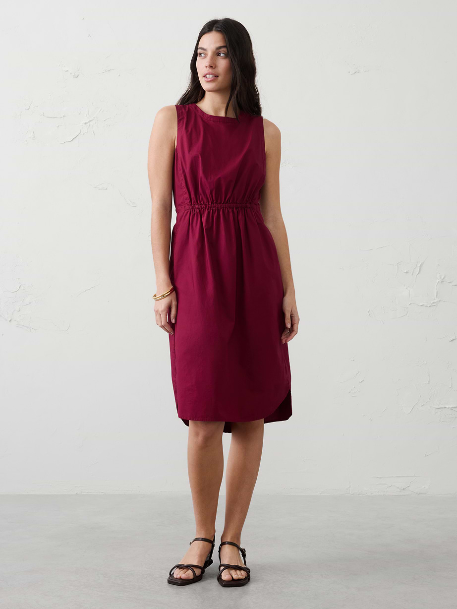 Woman in red dress and black sandals.
