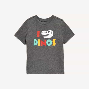 Dark gray kids’ T-shirt with colorful text “I DINOS” and a white T‑rex skull replacing the heart.