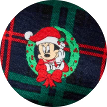 Minnie Mouse in a Santa hat inside a green wreath on red-and-green plaid.
