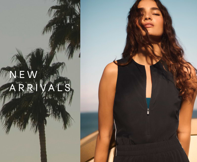 a woman in a black dress standing next to a palm tree