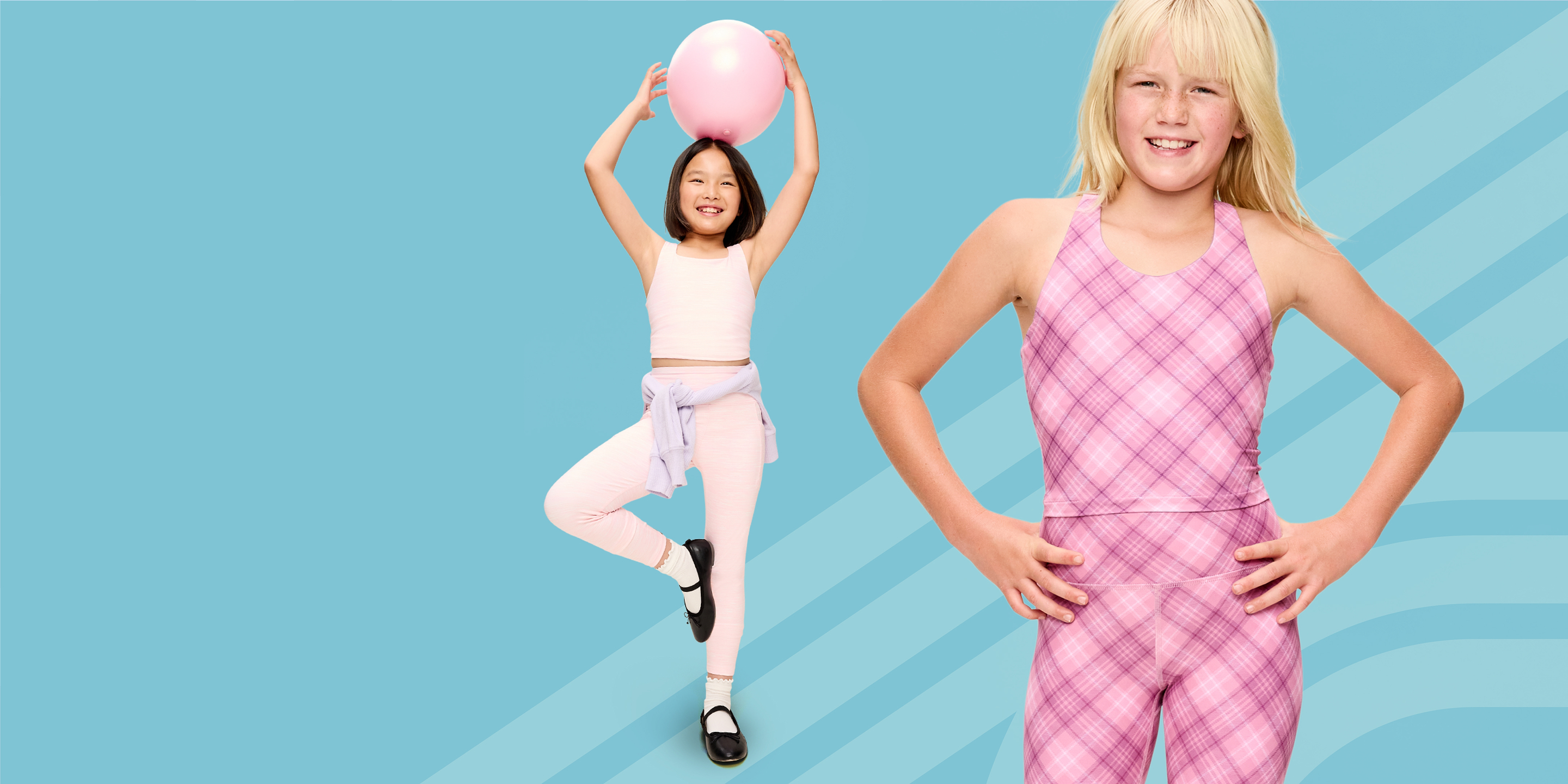 Two kids in pink activewear on a blue background—one balances on one leg holding a pink ball overhead; the other smiles with hands on hips in a pink plaid outfit.