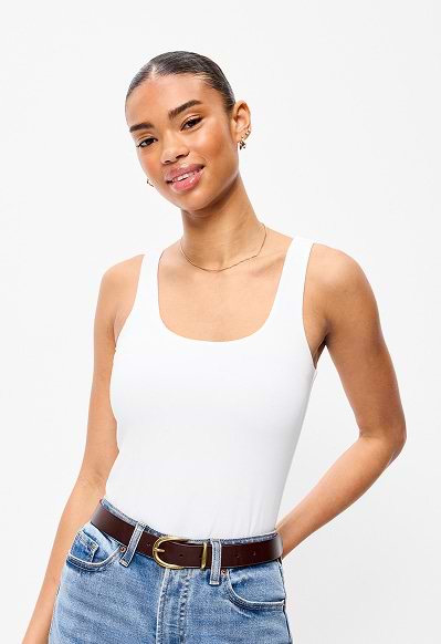 A female model wearing a white bodysuit.