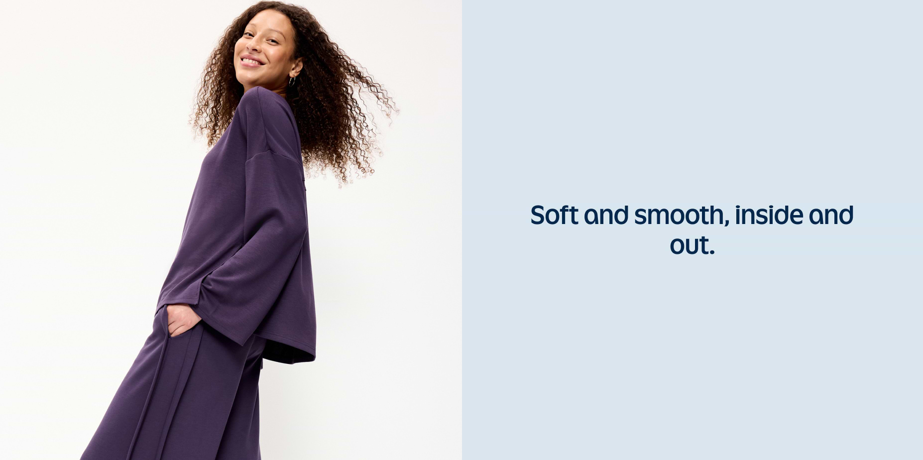 Smiling person in relaxed-fit purple sweatshirt and wide-leg pants; text beside reads “Soft and smooth, inside and out.”