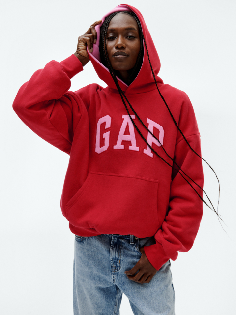 a woman in a gap hoodie is posing for a picture