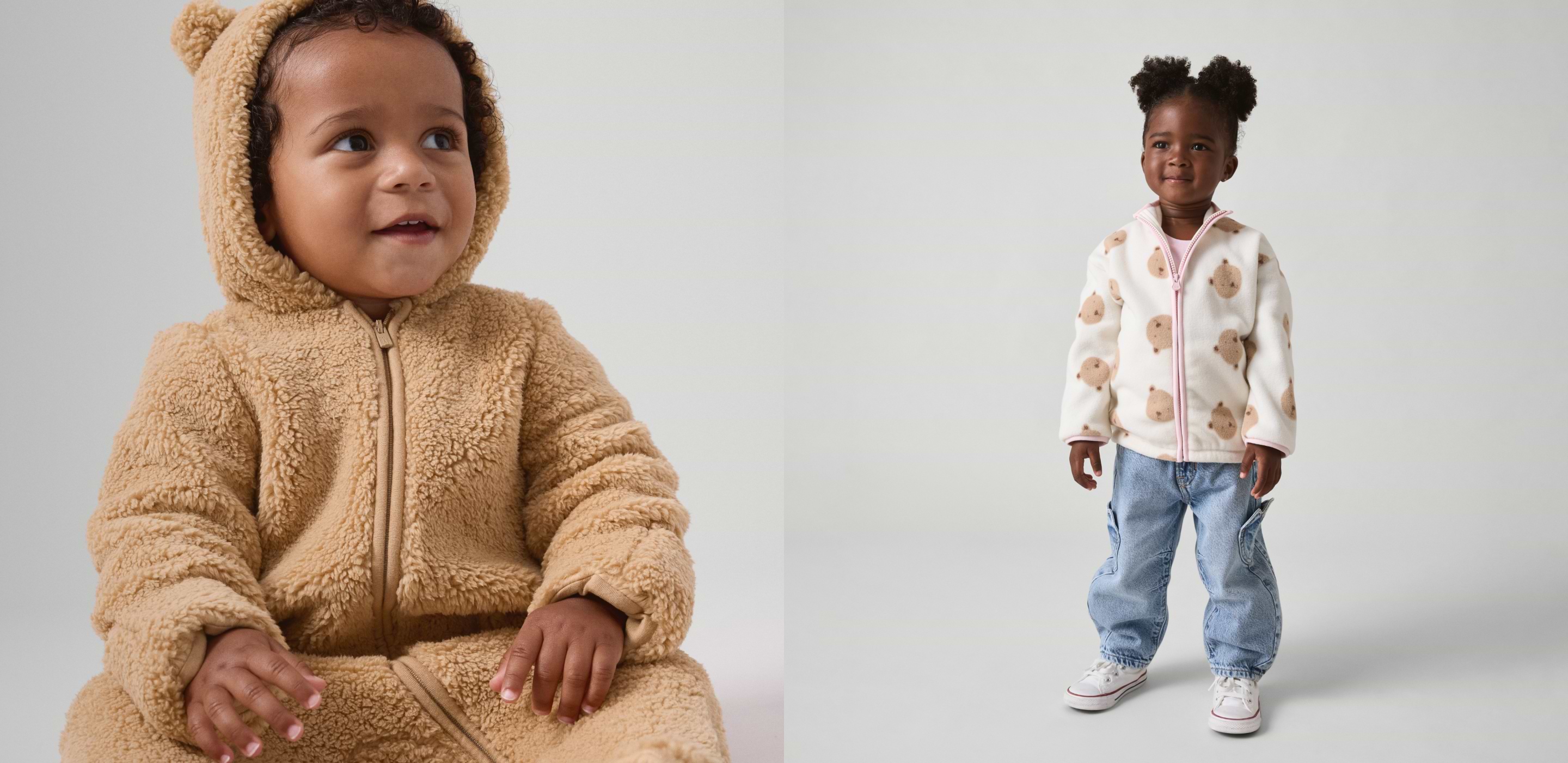 Two toddlers in cozy fleece: left wears a tan hooded onesie with bear ears; right wears a white bear-print zip jacket with jeans.