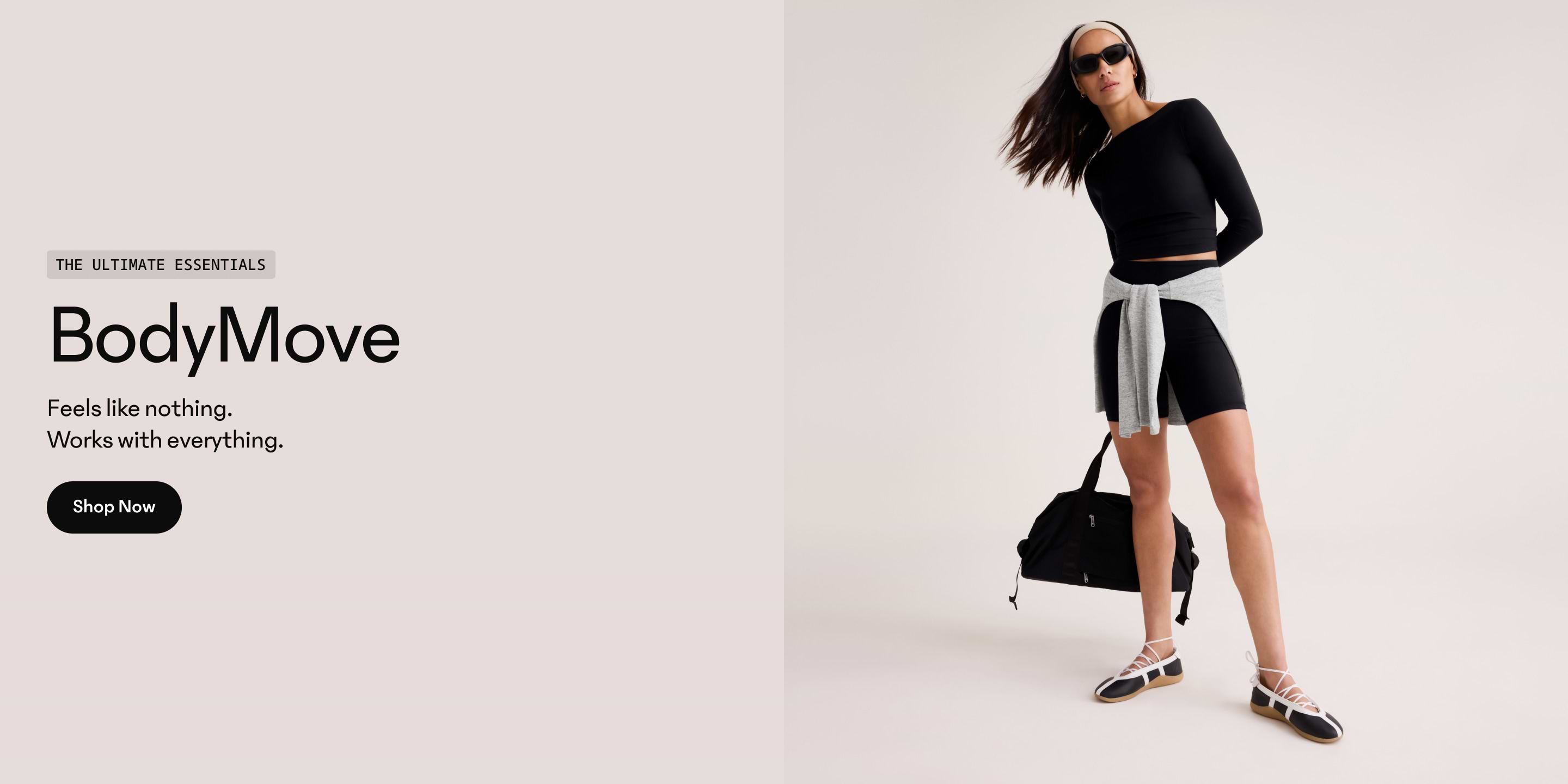 Person in black workout set with gray sweatshirt tied at the waist holding a black gym bag; “BodyMove” ad text reads “Feels like nothing. Works with everything.”