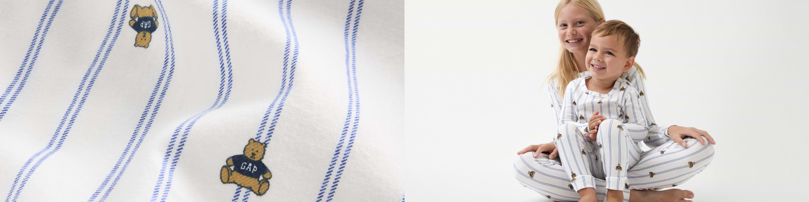 Two children sit smiling in matching white pajamas with blue pinstripes and small teddy bear prints; close-up shows the same fabric pattern.
