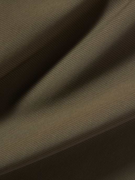 Close-up of olive-brown fabric with diagonal folds and a fine ribbed texture.