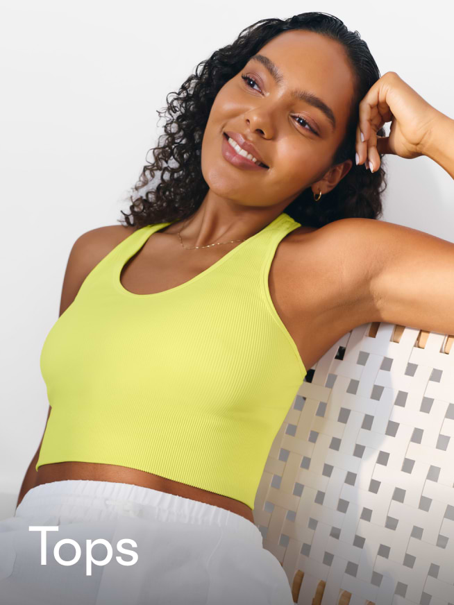 a woman in a yellow top sitting on a chair