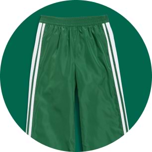 Green track pants with white side stripes.