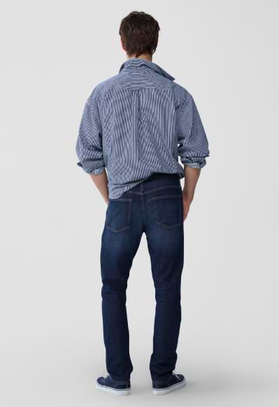 A male model wearing slim jeans.