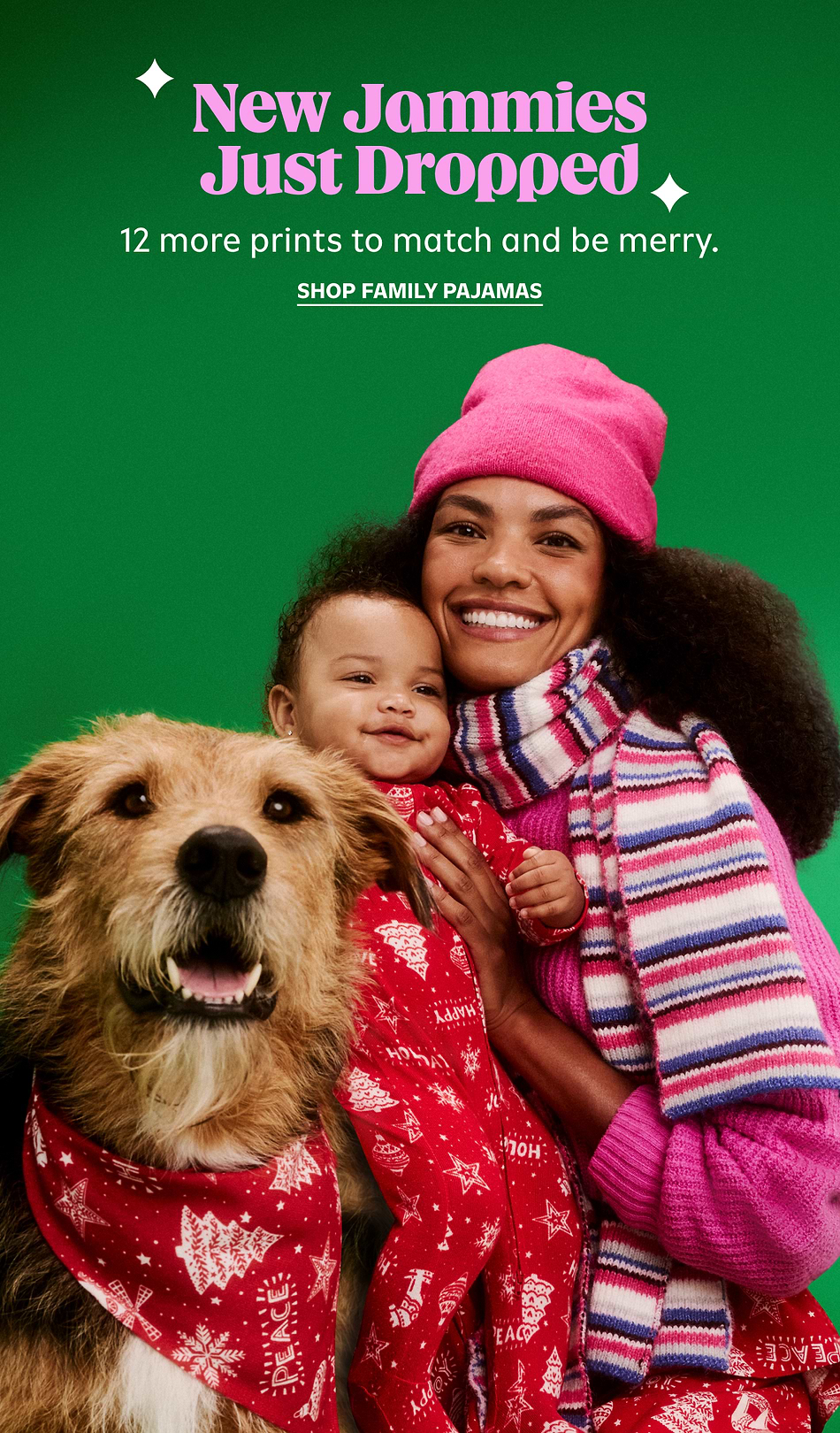 Holiday ad: smiling woman holding a baby in red pajamas beside a shaggy dog in a red bandana on a green backdrop; text reads “New Jammies Just Dropped—12 more prints. Shop family pajamas.”