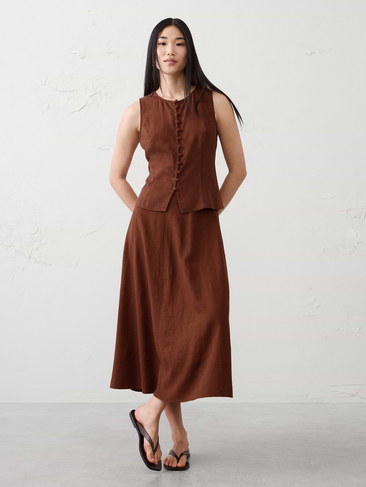 Woman in brown top and matching skirt.