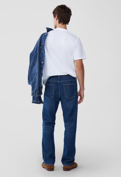 A male model wearing straight jeans.