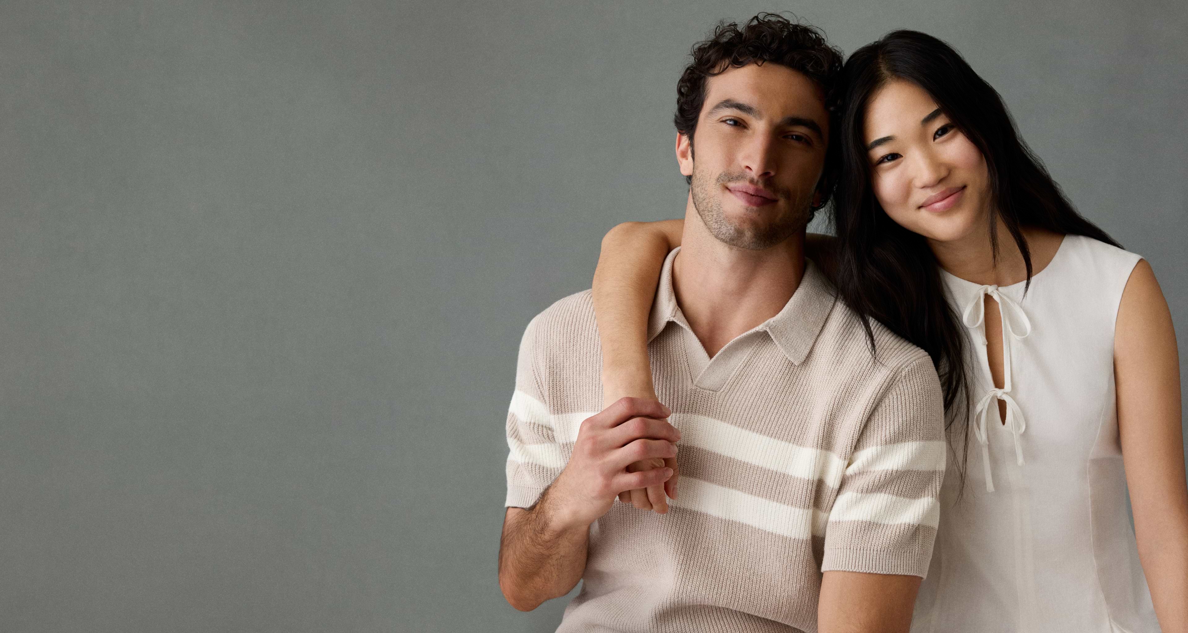 Man in tan striped polo and woman in white top.