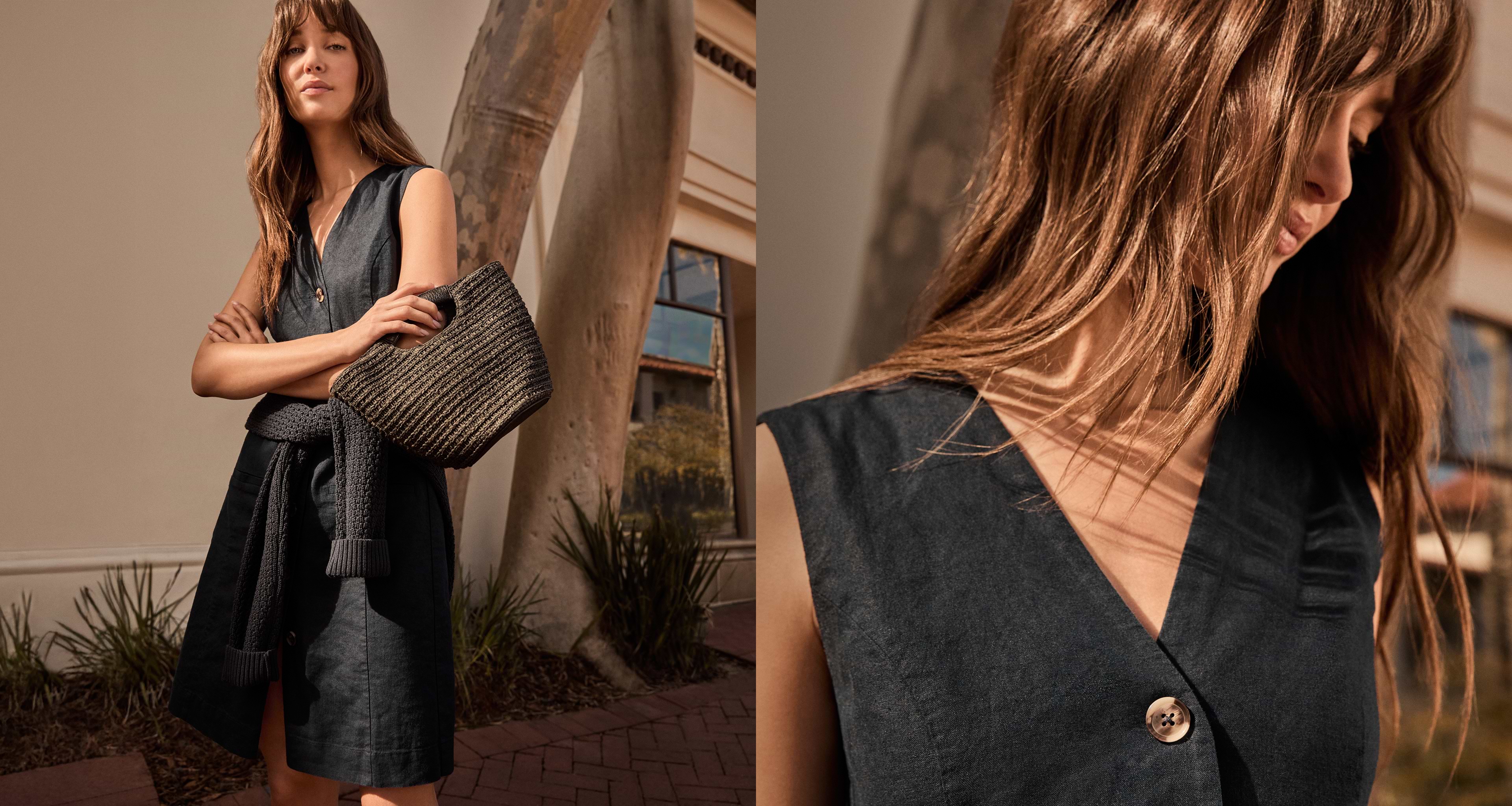 Woman in black linen dress and purse.