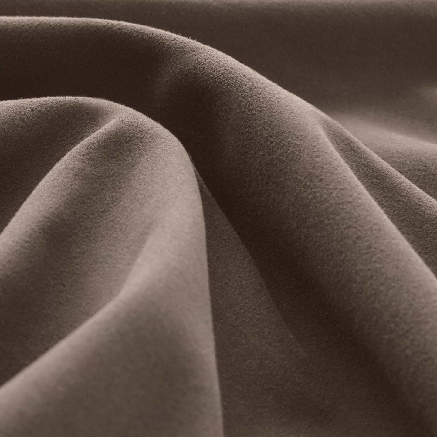 Close-up of soft brown fabric with smooth, gentle folds.