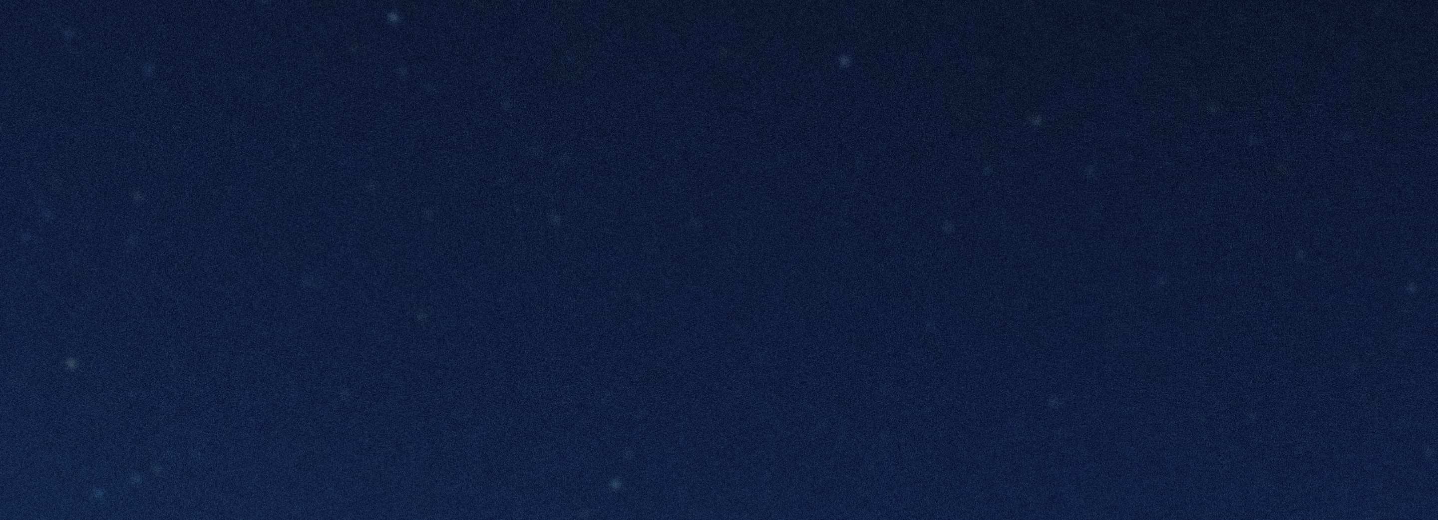 Dark blue night sky with scattered faint stars.