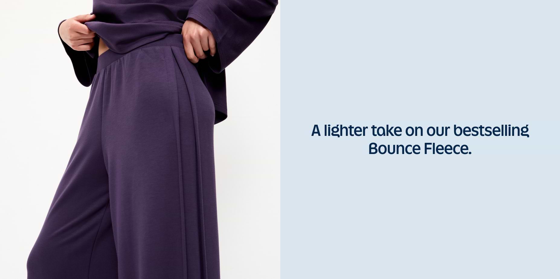Close-up of a person wearing dark purple fleece lounge pants and top; text reads “A lighter take on our bestselling Bounce Fleece.”