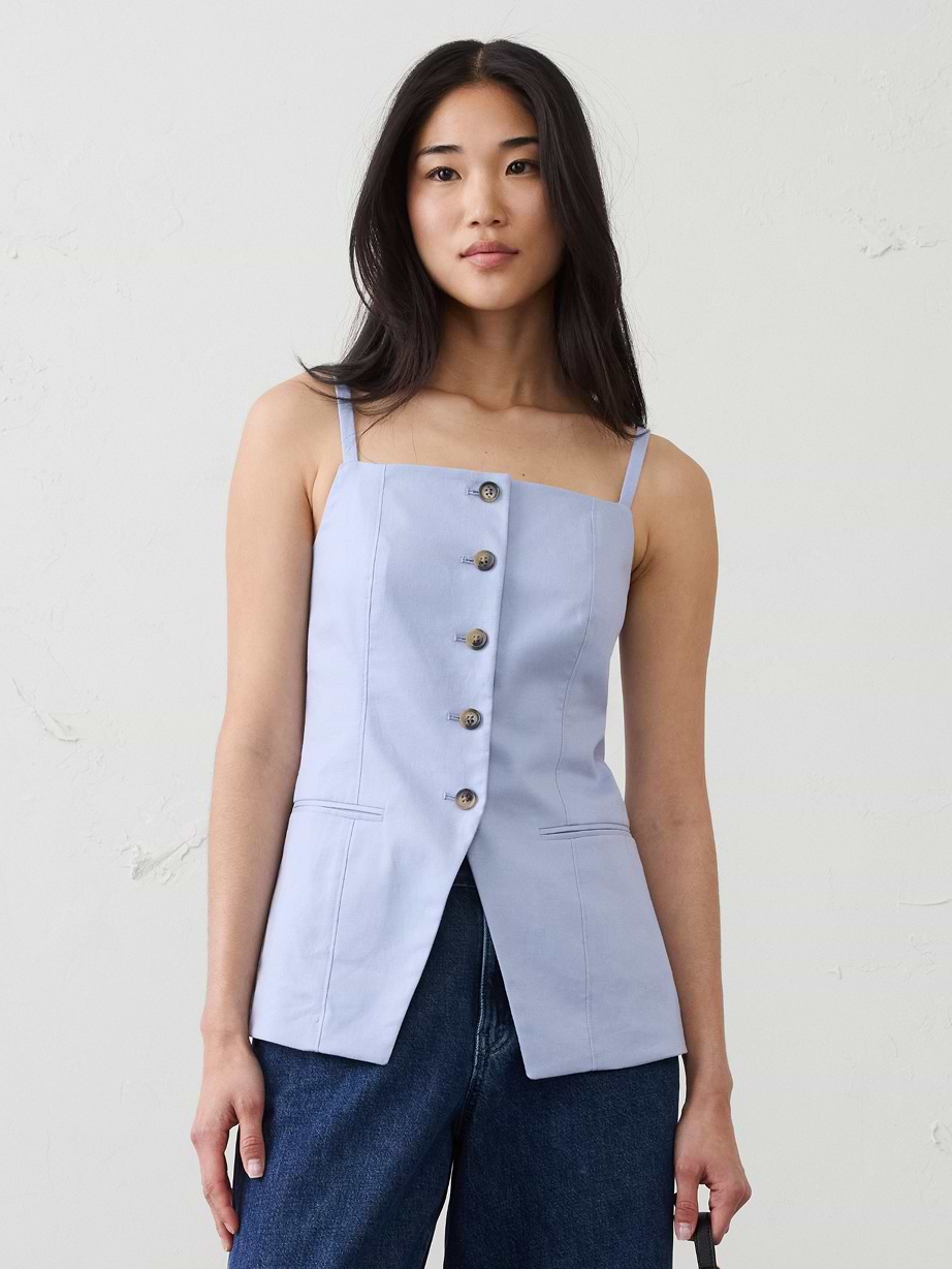 Woman in blue linen top and jeans.