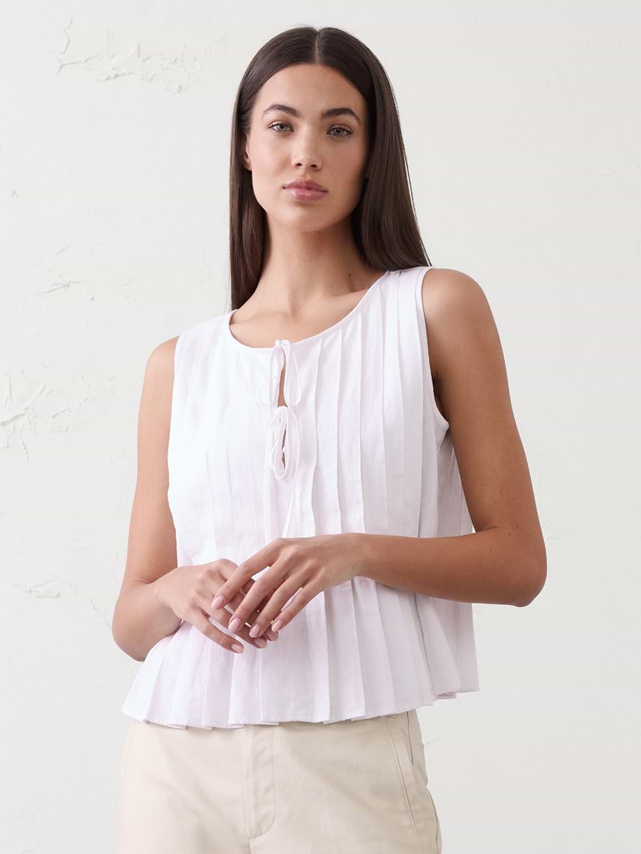 Woman in white sleeveless top. 