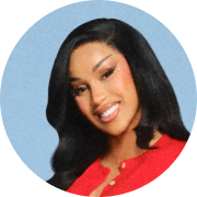 Image of Cardi B in a red SoSoft cardigna, blue background.