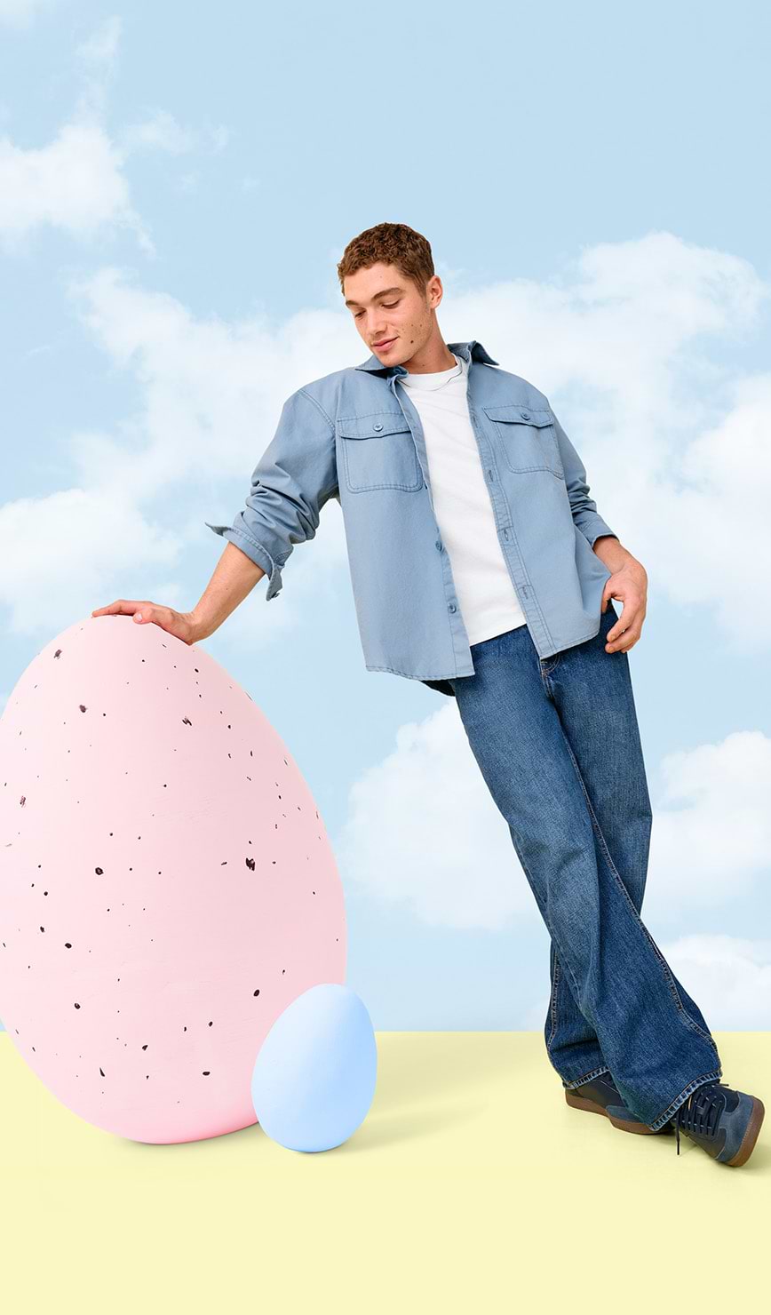 Male model posing next to an easter egg.