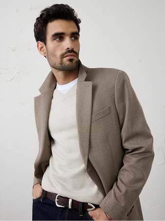 Person in a light blue fitted T-shirt and jeans, looking to the side.