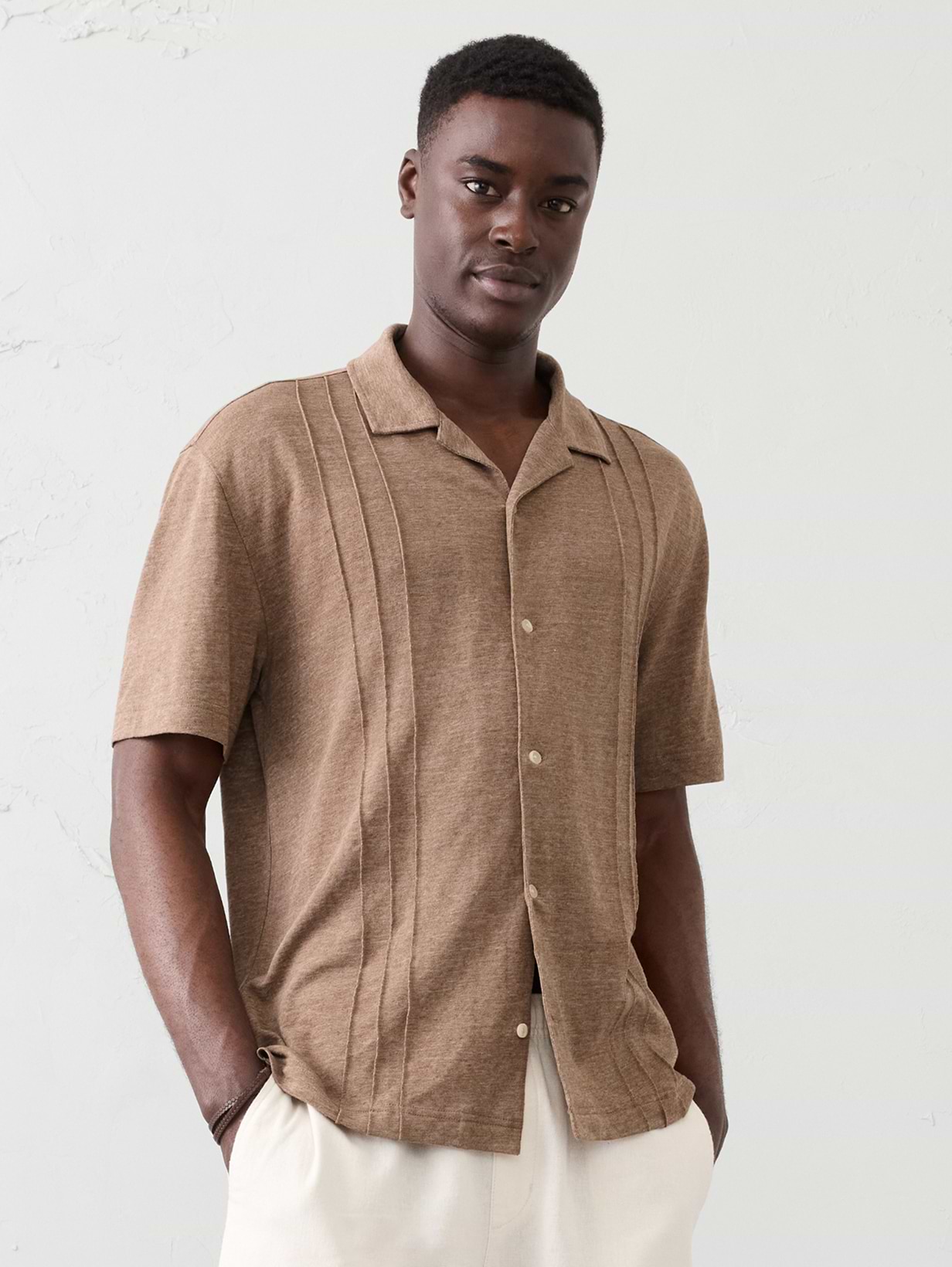 Man in brown button down shirt. 