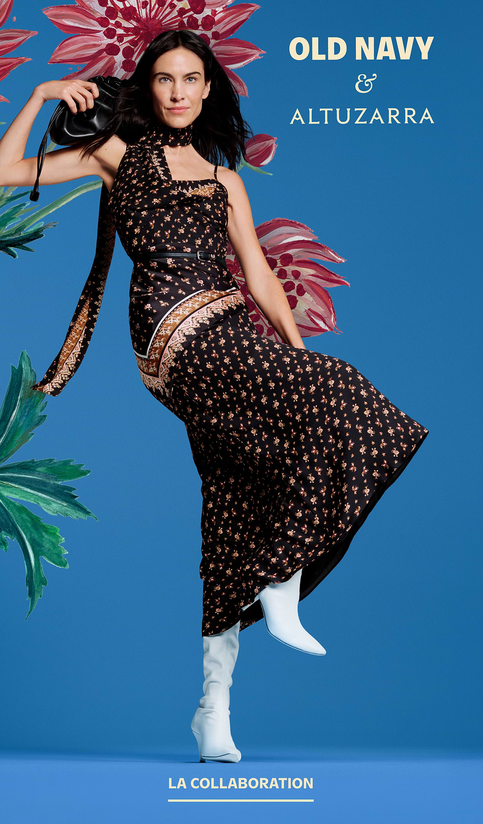 Alt text: Smiling girl in a blue floral dress holds an adult’s hand against a blue backdrop; Old Navy x Altuzarra ad.