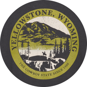 Vintage circular badge reading “Yellowstone, Wyoming” and “The Cowboy State since 1890,” featuring a mountain, lake, pine trees, and a silhouette of a rider on horseback.