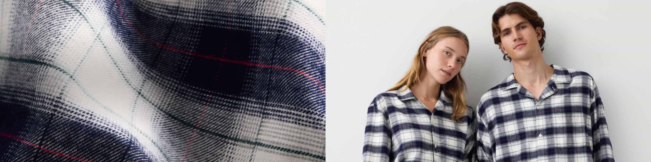 Close-up of navy, white, and red plaid flannel; two people wearing matching plaid button-up shirts against a white wall.