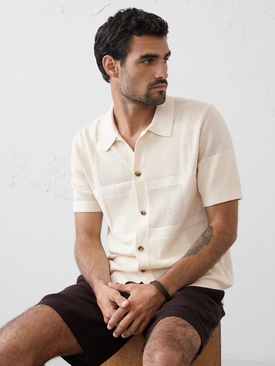 Man in tan polo and shorts.