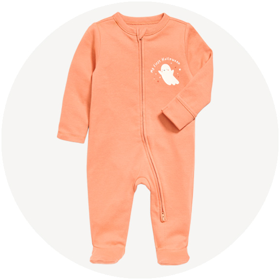 Peach long-sleeve baby sleeper with asymmetrical zipper to the left leg and a white ghost graphic reading “My First Halloween.”