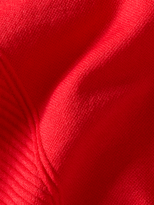 Close-up of light pink knit fabric with a folded ribbed cuff.