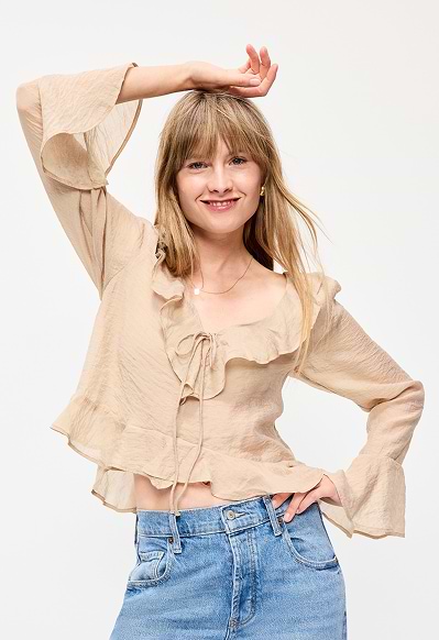 A female model wearing long-sleeve blouse.