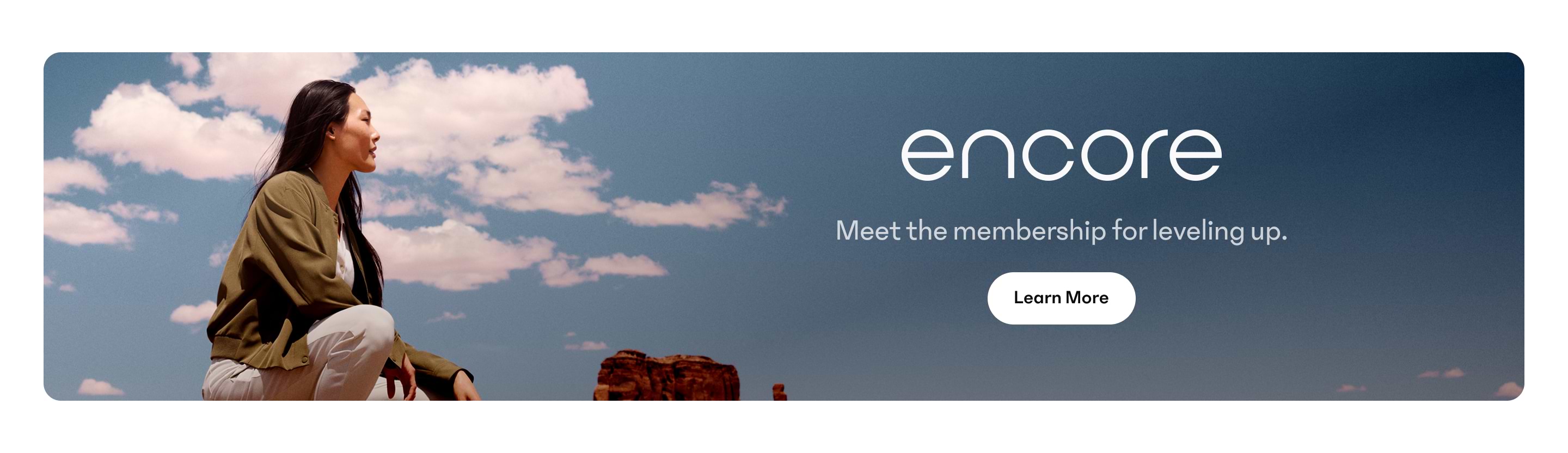 Promotional banner with a person sitting outdoors under a cloudy blue sky; text reads “encore — Meet the membership for leveling up.” with a “Learn More” button.