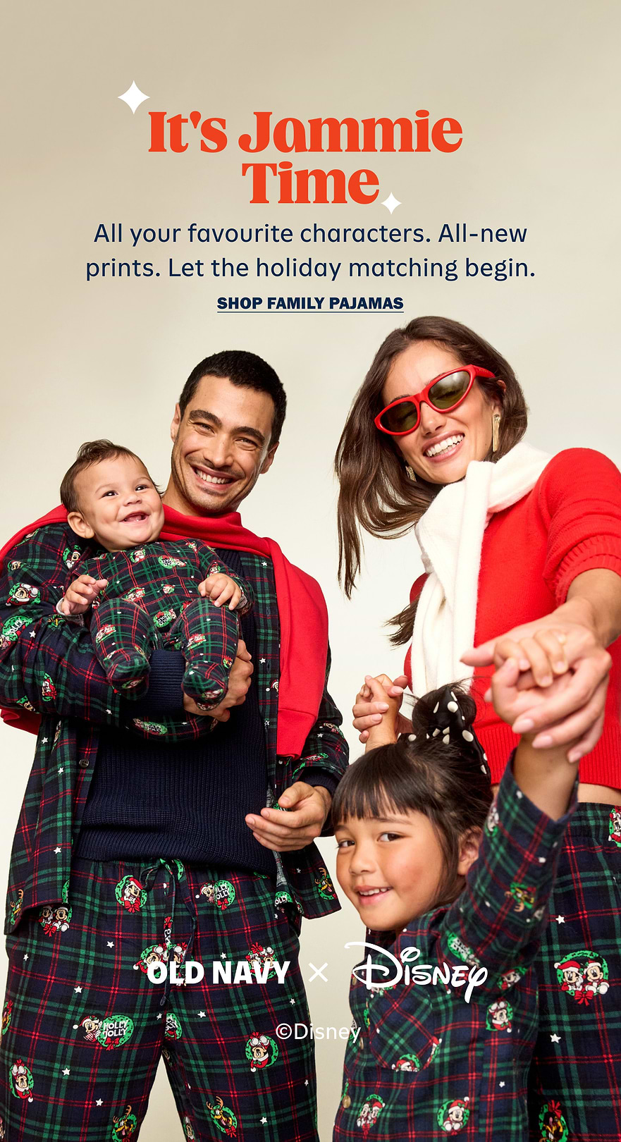 Smiling family in matching plaid Disney holiday pajamas; text reads “It’s Jammie Time—All-new prints. Shop family pajamas.” Old Navy x Disney ad.