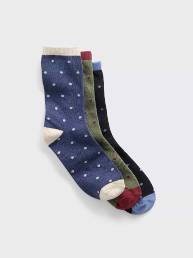 Three polka-dot crew socks—navy, olive, and black—with contrasting heels, toes, and cuffs.