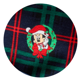 Minnie Mouse in a Santa hat inside a green wreath with a red bow, set on a red and green plaid background.