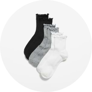 Four ankle socks in black, dark gray, light gray, and white with ruffled scalloped cuffs.