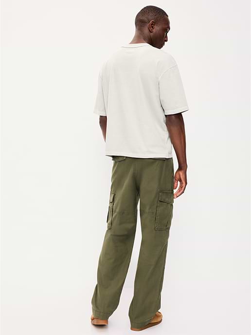 Back view of a person wearing a light gray T‑shirt and olive-green cargo pants with side pockets against a plain white background.