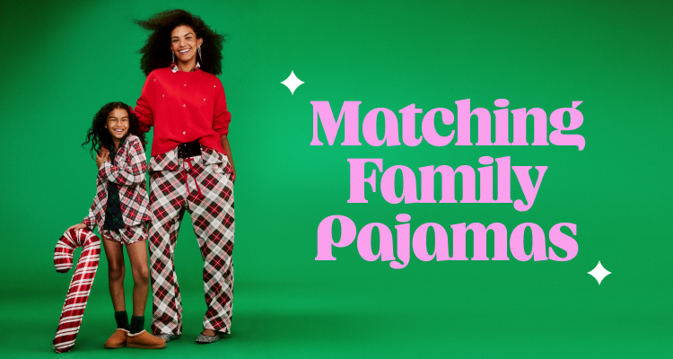Adult and child in matching red-and-plaid holiday pajamas on a green backdrop, one holding a large candy cane prop; text reads “Matching Jingle Jammies.”