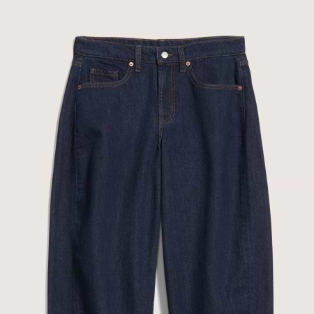 Dark indigo denim jeans, front view, classic five-pocket design with contrast stitching and button closure.