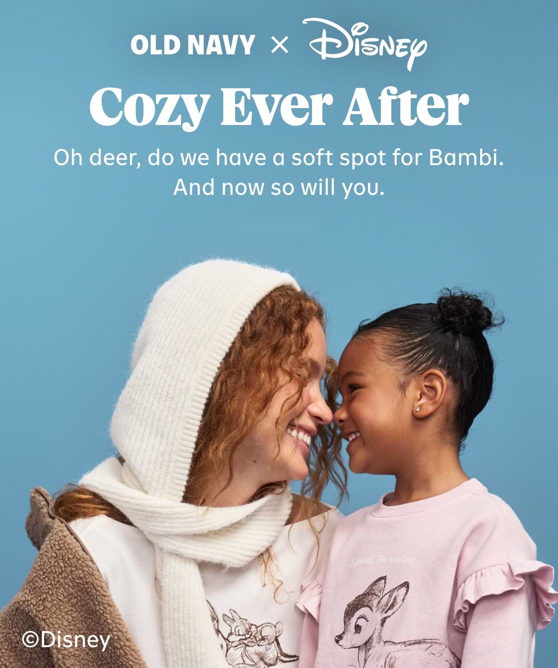 Adult and child touch noses while wearing pastel Disney‑themed Old Navy sweatshirts, against a blue background with the text “OLD NAVY x Disney.”